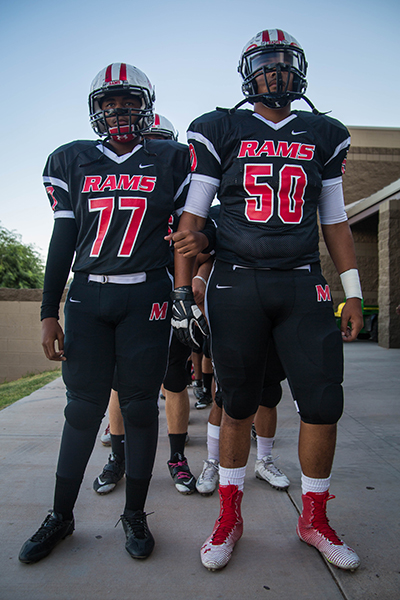 Seniors Mekhi Burch (77) and Johnny Smith prepare to take the field. Photo by William Lange