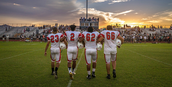 Cody DiCenzi, Kenny Oliver, NIckolas Carbejal and Dakota Halverson walk out for the sunset coin toss. Photo by William Lange