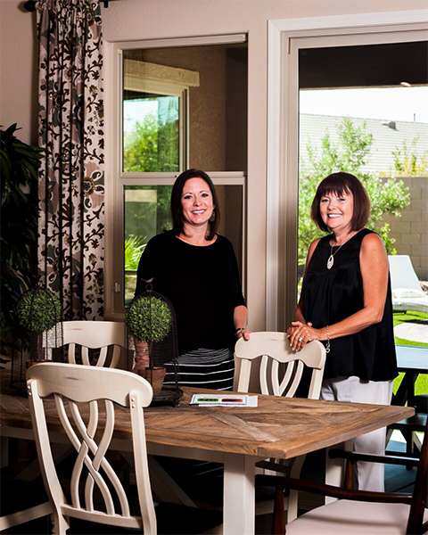 Amy Zinger (left) and Teri Cifalia on the back patio of new model of KB Home, which is one of the homebuilders that recently renewed focus on Maricopa. Photo by Glynn Thrower