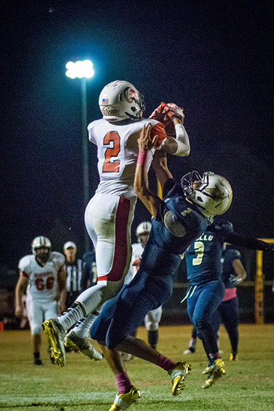 Kenny Oliver goes up for a pass reception late in the game. Photo by William Lange