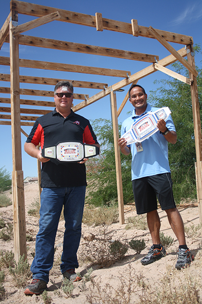 Park Manager Mike Riggs (left) and fitness coordinator Matthew Reiter show off the belts awaiting winners of the 2016 Mud Run.