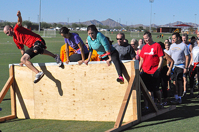 Last year's competitors leap over obstacles in the "clean" part of the run.