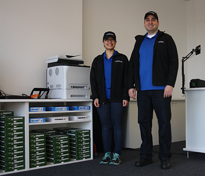 Cindy and Joe Licata are busy setting up supplies in their new business, Postmaster Depot. Photo by Raquel Hendrickson