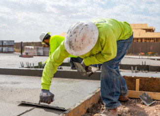 Tony Arroyo, a concrete finishing expert with 18 years of experience, works on a new model home at The Trails, a residential construction site for new homes, taken May 10. [Bryan Mordt]