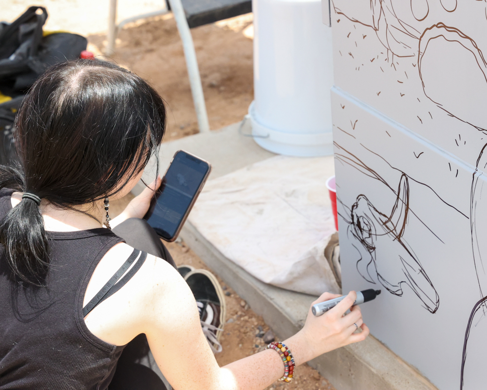 Anisa Burke sketches her design for "Friends of the Sonoran Desert" on June 8, 2023. [Brian Petersheim Jr.]