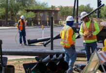 Construction teams install a traffic light at West Smith Enke Road and Chase Drive on June 7, 2023. [Brian Petersheim Jr.]