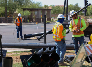 Construction teams install a traffic light at West Smith Enke Road and Chase Drive on June 7, 2023. [Brian Petersheim Jr.]