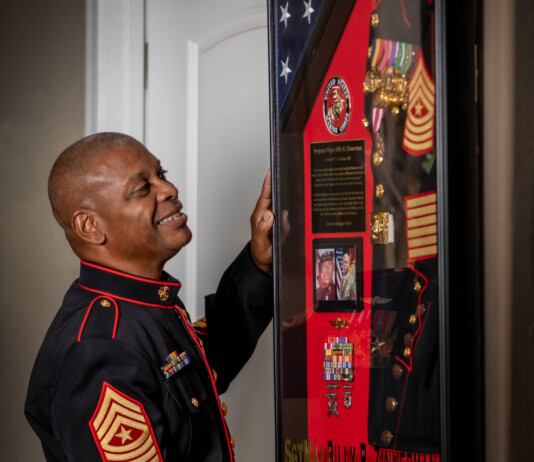 Zinnerman shows off a collection of bogus badges, medals and other accolades at his Maricopa home. [Victor Moreno]
