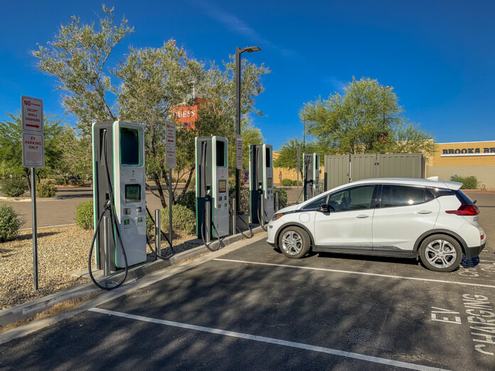 A Chevrolet Bolt sits in front of a row of electric vehicle charging stations in this undated photo. [Courtesy of Arizona Department of Transportation]