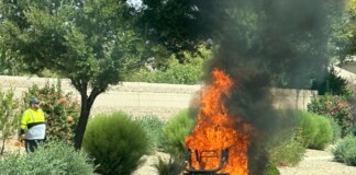 A flame throwing lawn mower in Rancho El Dorado. [Victor Moreno]