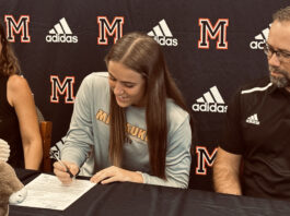 With parents Chani and Jason looking on, Maricopa High School's Abby Kuehnl signs her letter of intent to play DI soccer at UW-Milwaukee. [Jeff Chew]
