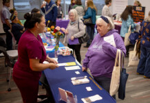 Clinical Liason Elaina Young of Compassus Hospice and Palliative Care speaks with an attendee at the Senior Info/Expo at the Maricopa Library and Cultural Center on Jan. 20, 2024. [Monica D. Spencer]