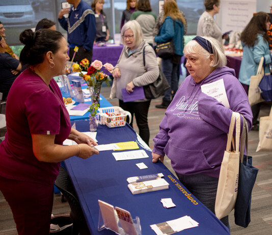 Clinical Liason Elaina Young of Compassus Hospice and Palliative Care speaks with an attendee at the Senior Info/Expo at the Maricopa Library and Cultural Center on Jan. 20, 2024. [Monica D. Spencer]