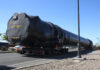 An oversized load carrying a SpaceX rocket travels down Honeycutt Road towards John Wayne Parkway on Feb. 21, 2024. Engine outlines can be seen on the back of the truck carrying the load. [Jeff Chew]
